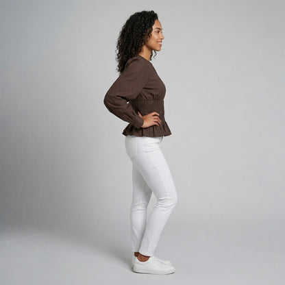 Professional e-commerce fashion photography — create a realistic product-on-model shot using the provided reference images. You are given 2 images: image 1 = product reference, image 2 = model reference. Dress the model from the second image in the product from the first image. The product must be physically placed on the model's body — worn naturally with correct fit, draping, and proportions as it would appear in real life. The product is the hero of the shot and must be clearly visible, prominently displ