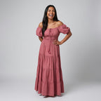 Professional e-commerce fashion photography — create a realistic product-on-model shot using the provided reference images. You are given 2 images: image 1 = product reference, image 2 = model reference. Dress the model from the second image in the product from the first image. The product must be physically placed on the model's body — worn naturally with correct fit, draping, and proportions as it would appear in real life. The product is the hero of the shot and must be clearly visible, prominently displ
