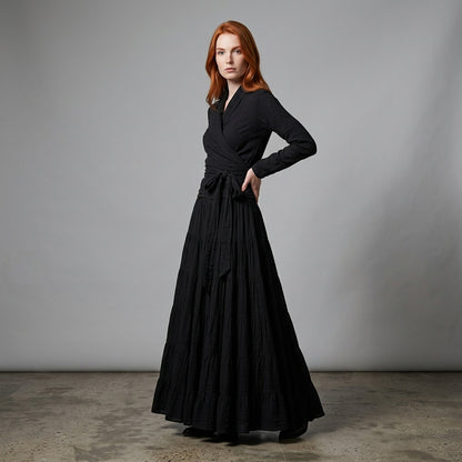 Professional e-commerce fashion photography — create a realistic product-on-model shot using the provided reference images. You are given 2 images: image 1 = product reference, image 2 = model reference. Dress the model from the second image in the product from the first image. The product must be physically placed on the model's body — worn naturally with correct fit, draping, and proportions as it would appear in real life. The product is the hero of the shot and must be clearly visible, prominently displ