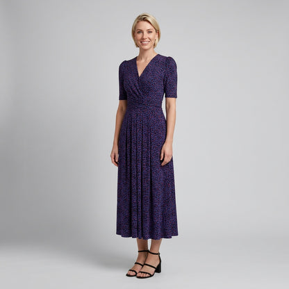 Professional e-commerce fashion photography — create a realistic product-on-model shot using the provided reference images. You are given 2 images: image 1 = product reference, image 2 = model reference. Dress the model from the second image in the product from the first image. The product must be physically placed on the model's body — worn naturally with correct fit, draping, and proportions as it would appear in real life. The product is the hero of the shot and must be clearly visible, prominently displ