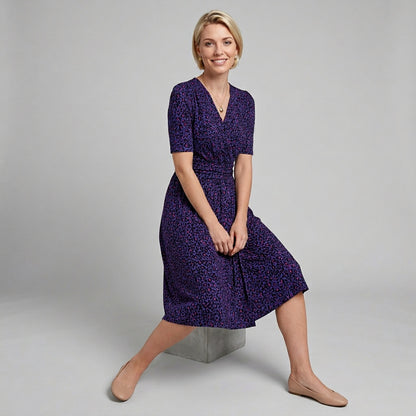 Professional e-commerce fashion photography — create a realistic product-on-model shot using the provided reference images. You are given 2 images: image 1 = product reference, image 2 = model reference. Dress the model from the second image in the product from the first image. The product must be physically placed on the model's body — worn naturally with correct fit, draping, and proportions as it would appear in real life. The product is the hero of the shot and must be clearly visible, prominently displ