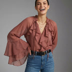 Professional e-commerce product photography, edit the provided images. Use the provided image as the product. Preserve the exact product shape, logo, colors, textures, and proportions. Do not alter, reshape, recolor, or add features to the product. clean studio backdrop, neutral grey gradient, flat even lighting, minimal shadows. upper body shot, waist up, torso and shoulders visible. joyful expressive face, laughing or mid-laugh, candid emotion. one hand on hip with the other arm behind back, legs close to