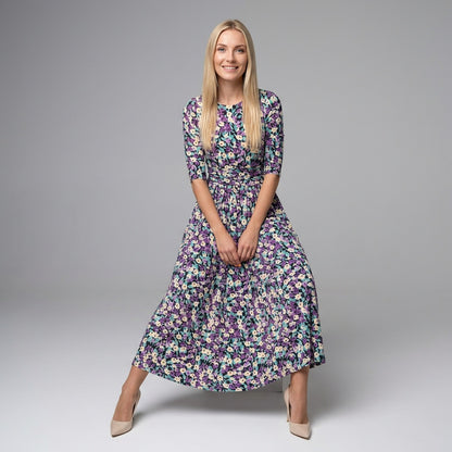 Professional e-commerce fashion photography — create a realistic product-on-model shot using the provided reference images. You are given 2 images: image 1 = product reference, image 2 = model reference. Dress the model from the second image in the product from the first image. The product must be physically placed on the model's body — worn naturally with correct fit, draping, and proportions as it would appear in real life. The product is the hero of the shot and must be clearly visible, prominently displ