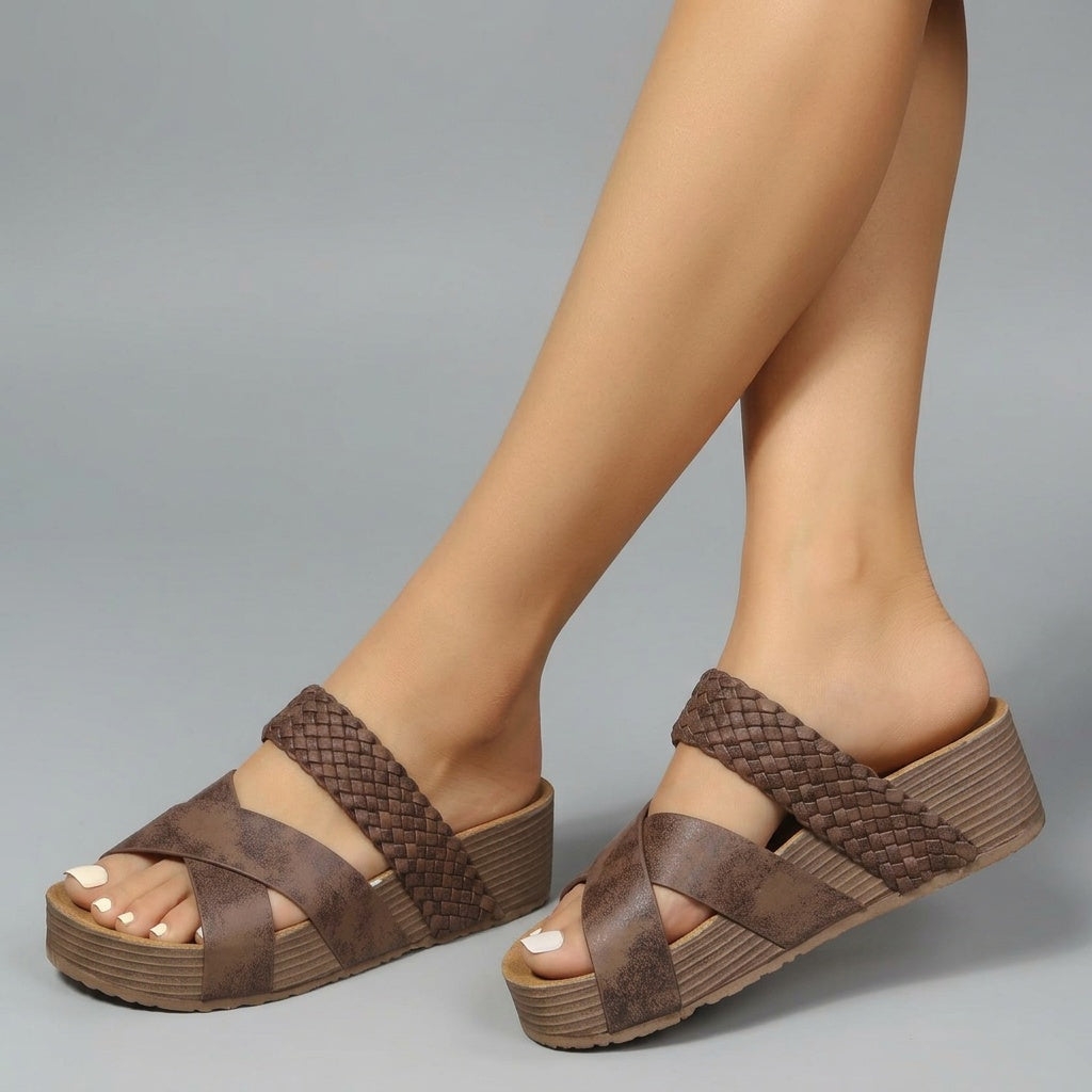 Professional e-commerce product photography, edit the provided images. Use the provided image as the product. Preserve the exact product shape, logo, colors, textures, and proportions. Do not alter, reshape, recolor, or add features to the product. clean studio backdrop, neutral grey gradient, flat even lighting, minimal shadows. close-up shot, head and neck, face and collar visible. high resolution, commercial quality, sharp focus

maak een uniek foto van deze sandalen. gebruik andere pose