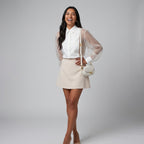 Professional e-commerce fashion photography — create a realistic product-on-model shot using the provided reference images. You are given 2 images: image 1 = product reference, image 2 = model reference. Dress the model from the second image in the product from the first image. The product must be physically placed on the model's body — worn naturally with correct fit, draping, and proportions as it would appear in real life. The product is the hero of the shot and must be clearly visible, prominently displ