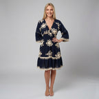 Professional e-commerce product photography, edit the provided images. You are given 2 images: image 1 = style reference, image 2 = model reference. clean studio backdrop, neutral grey gradient, flat even lighting, minimal shadows. Use the person from the second image as the model, adult european female model with long blonde hair, straight hairstyle, slim build, clean shaven professional fashion model. Match the overall style, lighting, and composition from the first image. full body shot, head to toe, com