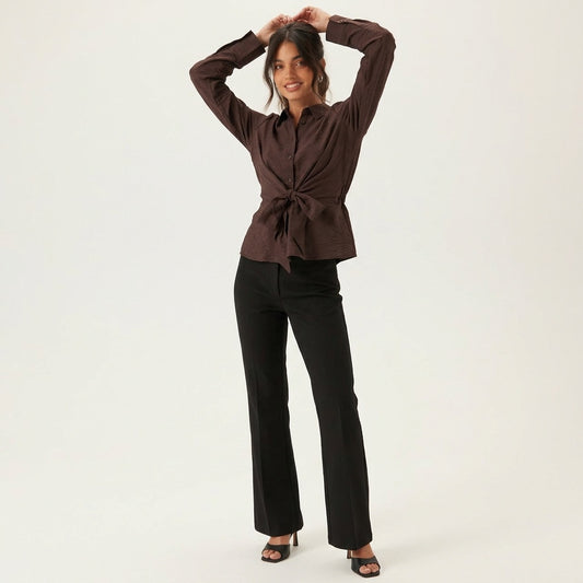 Professional e-commerce product photography, edit the provided images. You are given 4 images: image 1 = product reference, image 2 = product reference, image 3 = product reference, image 4 = product reference. Use the product images (images 1, 2, 3, 4) as the product. Preserve the exact product shape, logo, colors, textures, and proportions. Do not alter, reshape, recolor, or add features to the product. full body shot, head to toe, complete figure visible. natural warm smile, approachable and friendly exp